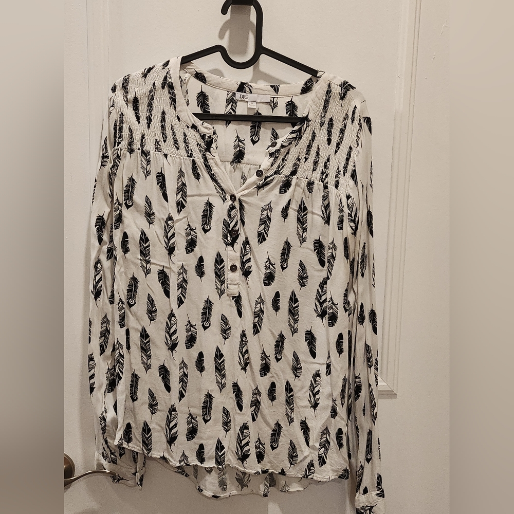 White blouse with black feathers